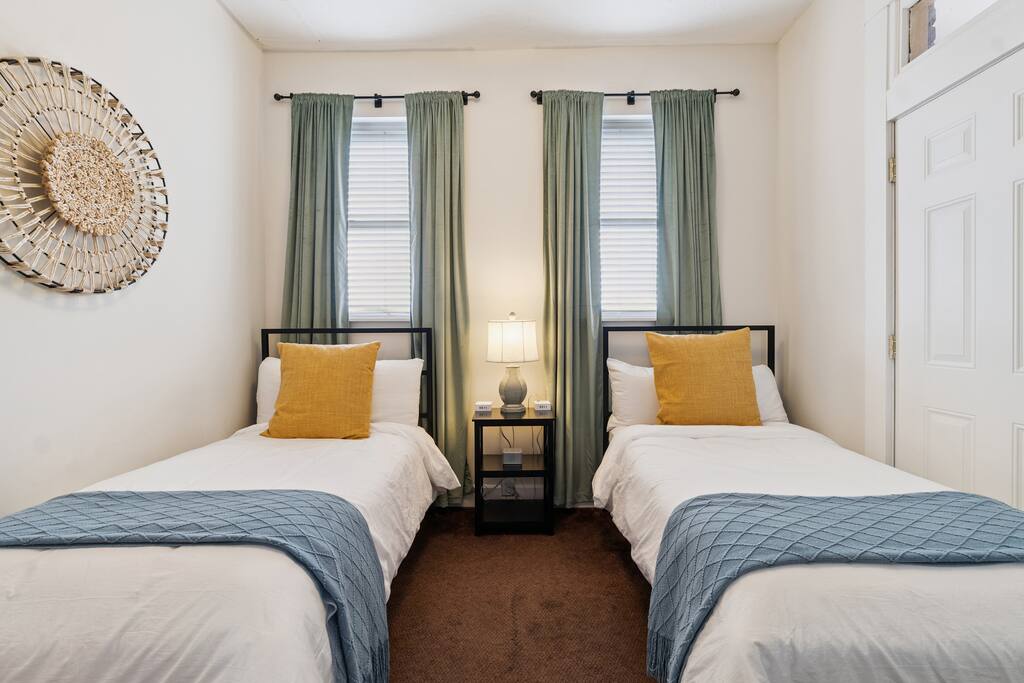 This bright and versatile bedroom offers two cozy twin beds, soft bedding, and plenty of natural light—ideal for kids, friends, or solo travelers  - Downtown | Family Friendly | Walk to the Choo Choo - Chattanooga