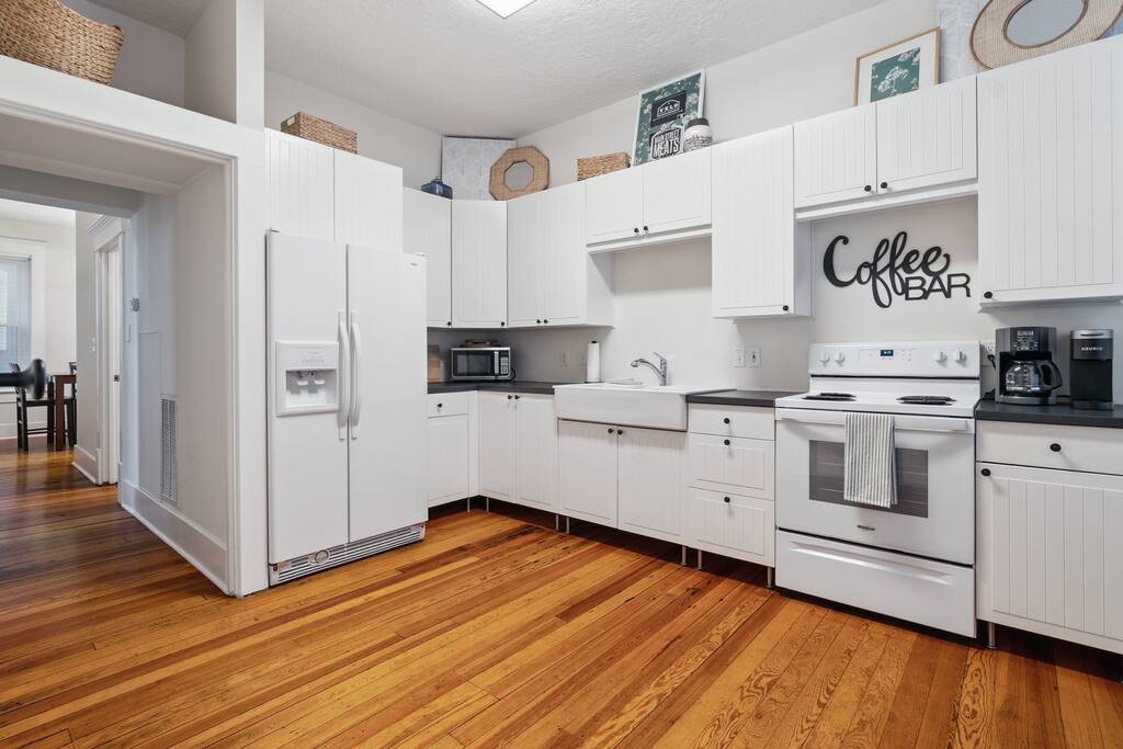 Whip up a homemade meal or plate up your favorite takeout in this bright downstairs kitchen, complete with a coffee bar, full-size fridge, and plenty of counter space—note: no dishwasher Whip up a homemade meal or plate up your favorite takeout in this bright downstairs kitchen, complete with a coffee bar, full-size fridge, and plenty of counter space—note: no dishwasher - In Southside | Roomy 6 Bedroom | Walk to Choo Choo - Chattanooga