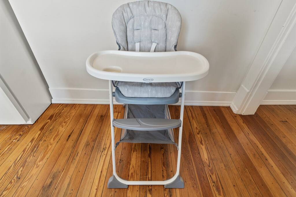 Perfect for families, a highchair is conveniently located next to the kitchen fridge and available for your use during your stay Perfect for families, a highchair is conveniently located next to the kitchen fridge and available for your use during your stay - In Southside | Roomy 6 Bedroom | Walk to Choo Choo - Chattanooga