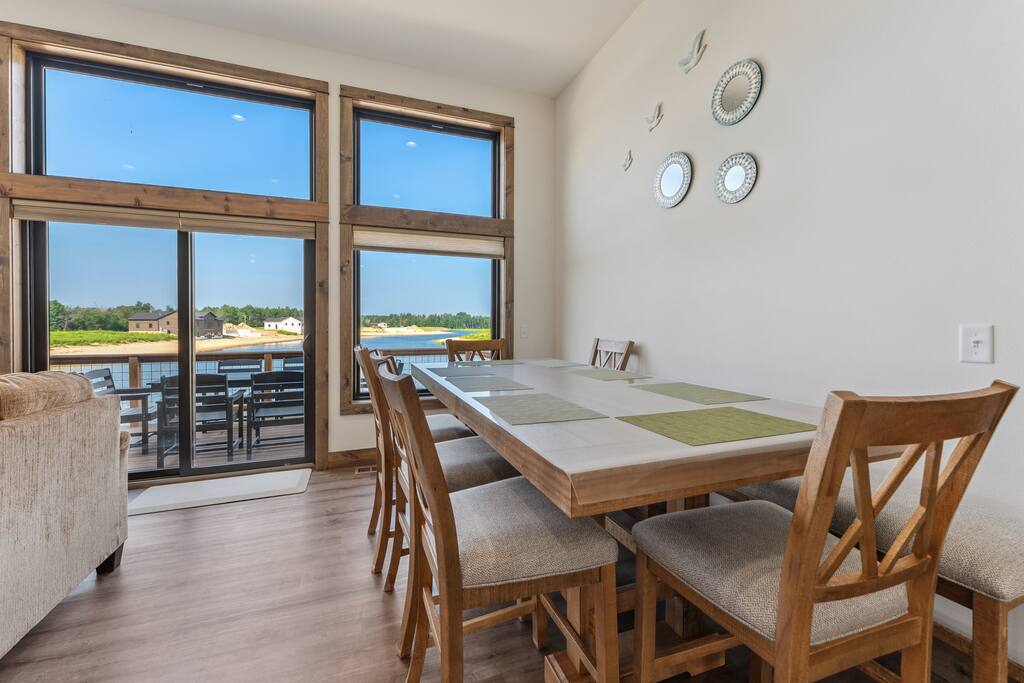 Dining area features large table with 6 chairs, bench seating and overlooks Sunset Lake. Dining area features large table with 6 chairs, bench seating and overlooks Sunset Lake. - New Listing Lakeside Beach Sleeps 15+ Pet friendly - New Lisbon