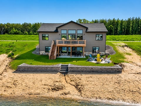 Sunshine Haven features 6 BD, 3 full bathrooms, 2 living rooms, along with a deck and patio, firepit, private access beach on Sunset Lake, outdoor and indoor games and activities, full kitchen and laundry. Room for everyone to relax and enjoy.