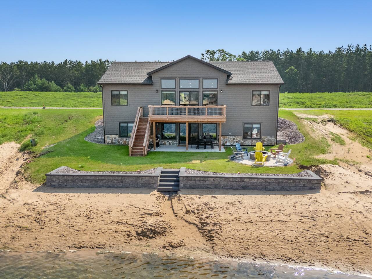 Sunshine Haven features 6 BD, 3 full bathrooms, 2 living rooms, along with a deck and patio, firepit, private access beach on Sunset Lake, outdoor and indoor games and activities, full kitchen and laundry. Room for everyone to relax and enjoy.