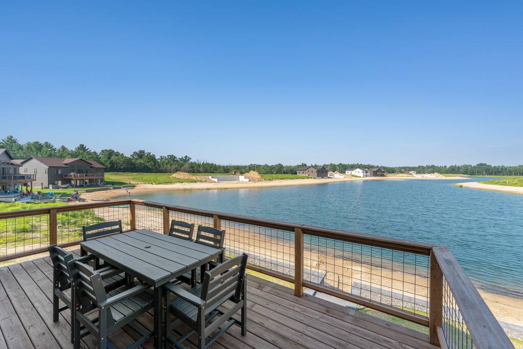 The deck is accessed through the upstairs sliding glass doors. It features a beautiful view of Sunset Lake, an outdoor dining set with 6 chairs and has access down to the patio, firepit area and beach via connected stairs. The deck is accessed through the upstairs sliding glass doors. It features a beautiful view of Sunset Lake, an outdoor dining set with 6 chairs and has access down to the patio, firepit area and beach via connected stairs. - New Listing Lakeside Beach Sleeps 15+ Pet friendly - New Lisbon