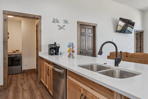 Bright open kitchen with spacious island, coffee station, and living room views