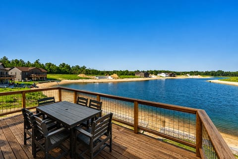 outdoor dining set w/6 chairs and has access down to the patio, firepit, beach
