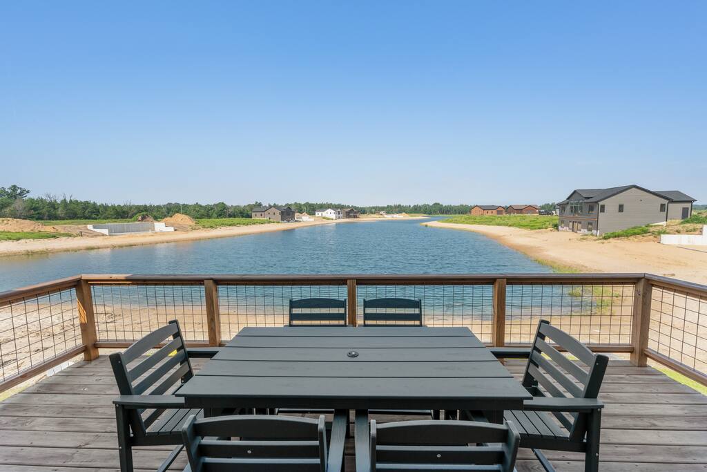 The deck is accessed through the upstairs sliding glass doors. It features a beautiful view of Sunset Lake, an outdoor dining set with 6 chairs and has access down to the patio, firepit area and beach via connected stairs. The deck is accessed through the upstairs sliding glass doors. It features a beautiful view of Sunset Lake, an outdoor dining set with 6 chairs and has access down to the patio, firepit area and beach via connected stairs. - New Listing Lakeside Beach Sleeps 15+ Pet friendly - New Lisbon