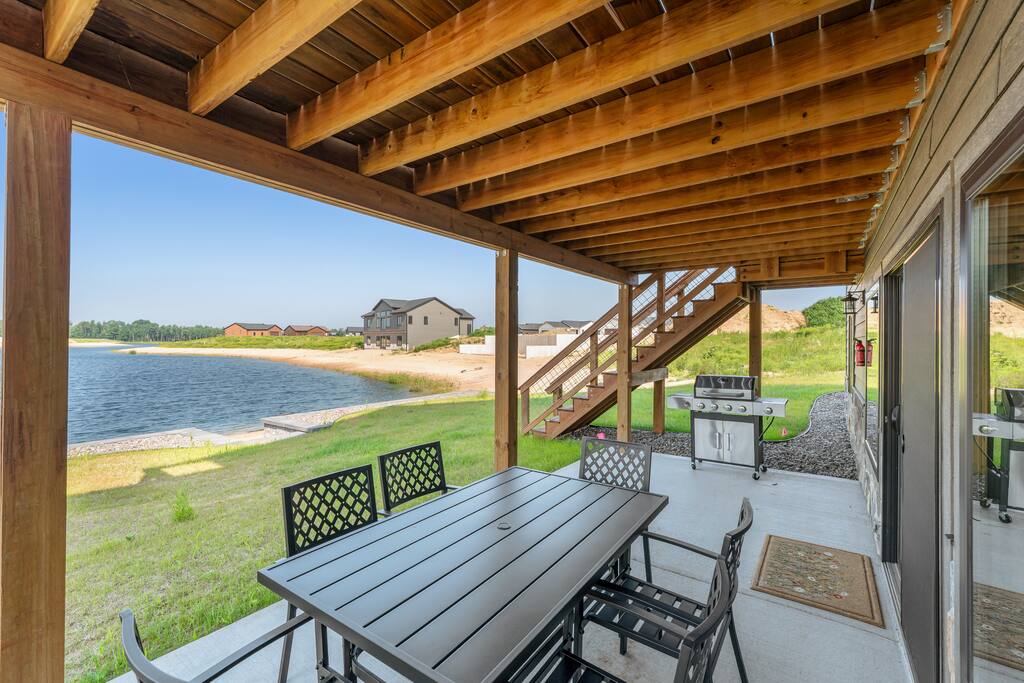 The patio can be accessed through the walk out basement or porch stairs and is sheltered by the porch above. It features an outdoor dining set with table and 6 chairs and propane grill for your use. Propane and grilling tools are provided. The patio can be accessed through the walk out basement or porch stairs and is sheltered by the porch above. It features an outdoor dining set with table and 6 chairs and propane grill for your use. Propane and grilling tools are provided. - New Listing Lakeside Beach Sleeps 15+ Pet friendly - New Lisbon