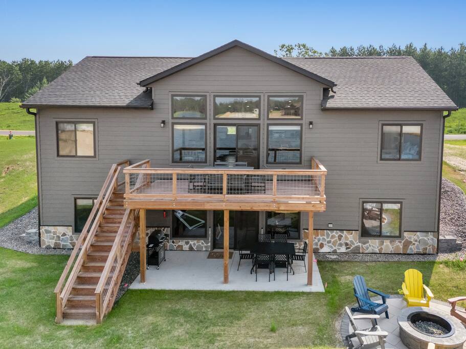 The deck is accessed through the upstairs sliding glass doors. It features a beautiful view of Sunset Lake, an outdoor dining set with 6 chairs and has access down to the patio, firepit area and beach via connected stairs. The deck is accessed through the upstairs sliding glass doors. It features a beautiful view of Sunset Lake, an outdoor dining set with 6 chairs and has access down to the patio, firepit area and beach via connected stairs. - New Listing Lakeside Beach Sleeps 15+ Pet friendly - New Lisbon