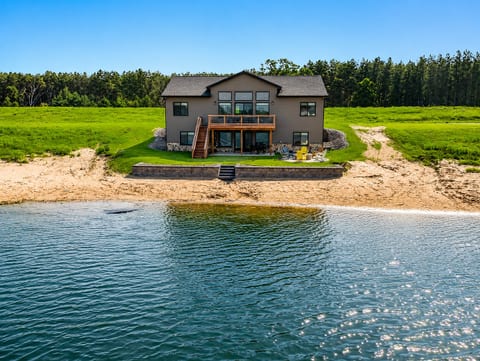 Sunshine Haven features 6 BD, 3 full bathrooms, 2 living rooms, along with a deck and patio, firepit, private access beach on Sunset Lake, outdoor and indoor games and activities, full kitchen and laundry. Room for everyone to relax and enjoy.