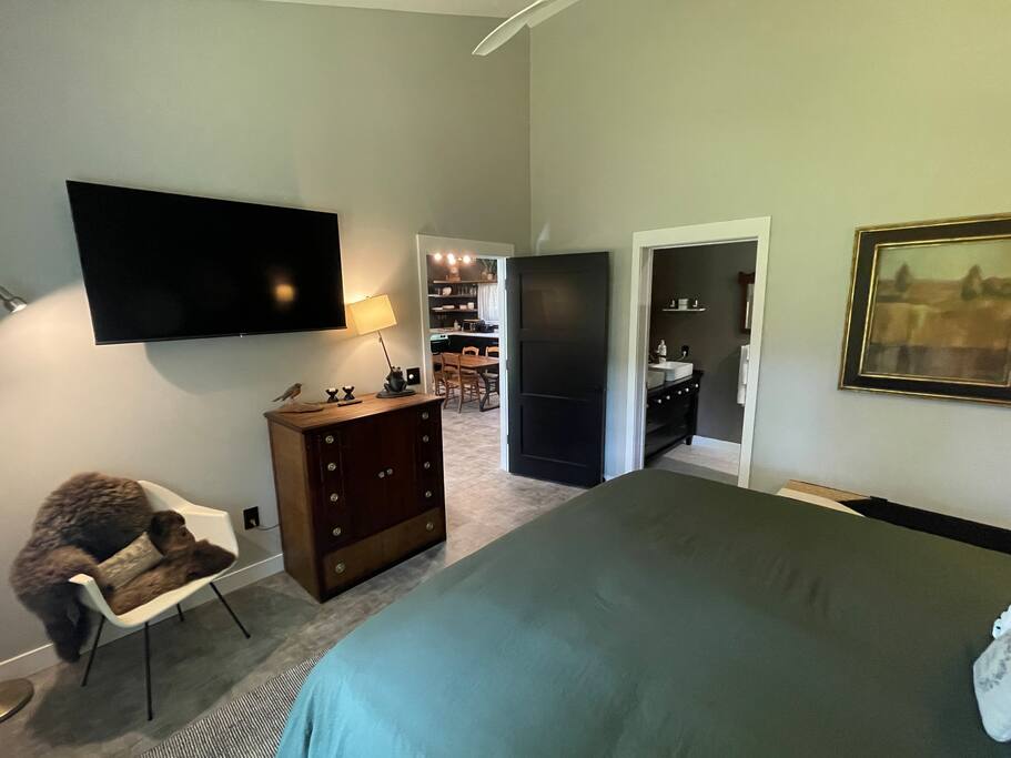 Master Suite Bedroom with a king bed, FireTV, dresser, hangers, end tables, reading lights, bench and 2 luggage folding racks. Master bathroom connected to the bedroom with shower, double sink, anti-fog /lighted mirror, bidet toilet and hair dryer. Master Suite Bedroom with a king bed, FireTV, dresser, hangers, end tables, reading lights, bench and 2 luggage folding racks. Master bathroom connected to the bedroom with shower, double sink, anti-fog /lighted mirror, bidet toilet and hair dryer. - New Listing 2BR/2BA on Trout Lake HotTub & Firepit - Wisconsin Dells