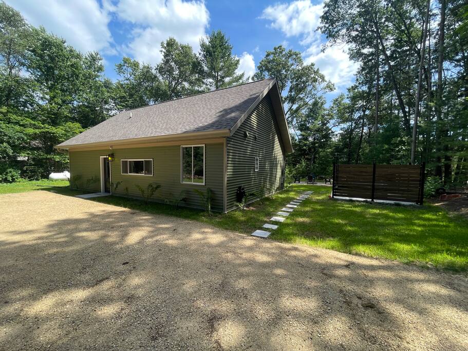 Exterior of home: Front of home with large gravel parking area and stepping stones to the hot tub and backyard. Exterior of home: Front of home with large gravel parking area and stepping stones to the hot tub and backyard. - New Listing 2BR/2BA on Trout Lake HotTub & Firepit - Wisconsin Dells