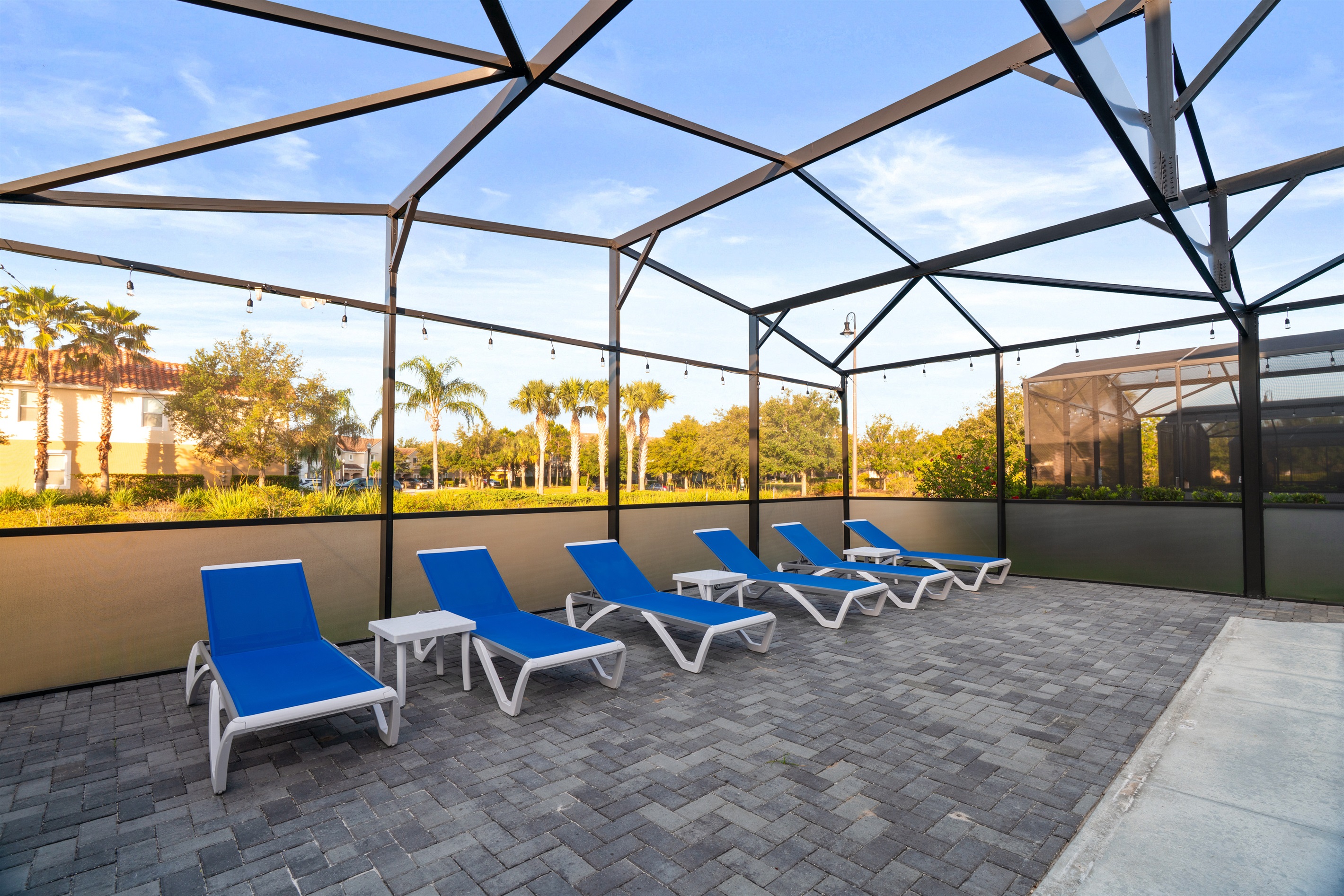 Unwind in your private retreat featuring an expanded pool with basketball hoop, six cushioned loungers, and a full outdoor dining area—perfect for both relaxation and entertaining.
