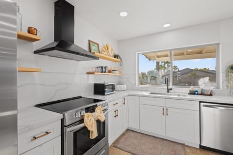 Kitchen with refrigerator, stove, coffee maker, and dishwasher