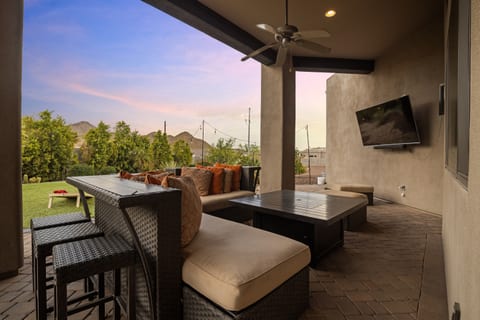 Sectional couch on patio with tv and soundbar