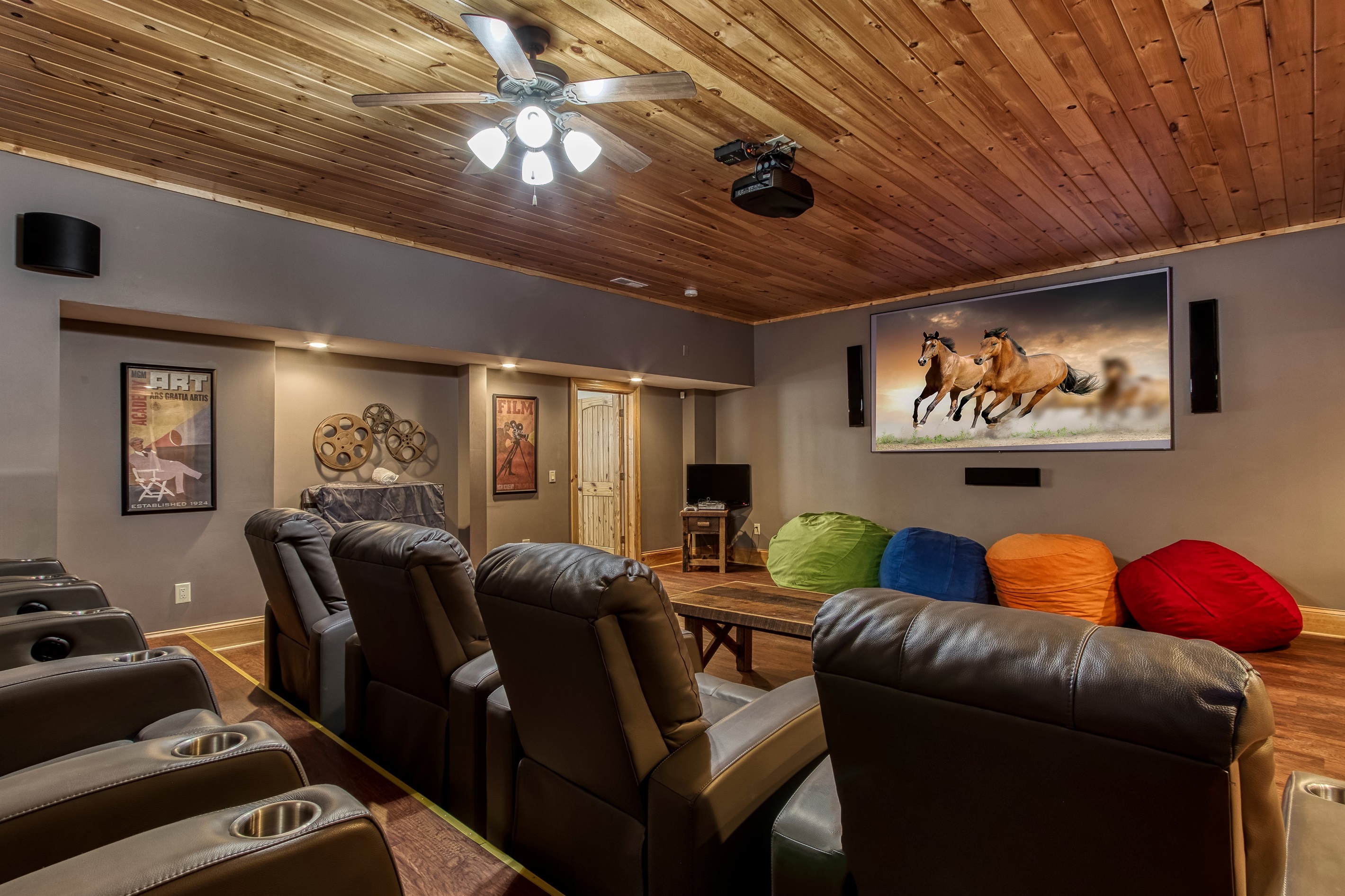 Private theater room with plush reclining seats and a large screen for movie nights in