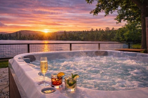 Toast the day from warm, bubbling water as the sun lowers across the pond—an indulgent waterfront experience made even better after hours outdoors.