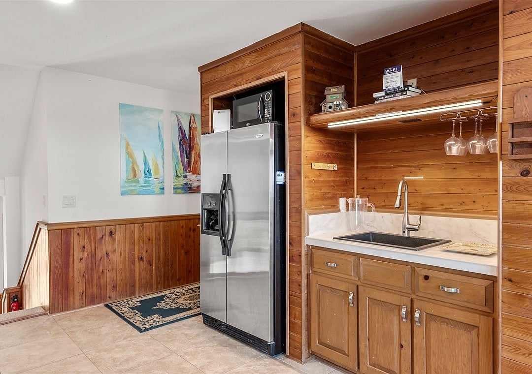 Full size 2nd fridge, sink, and microwave in thr lounge pool table area