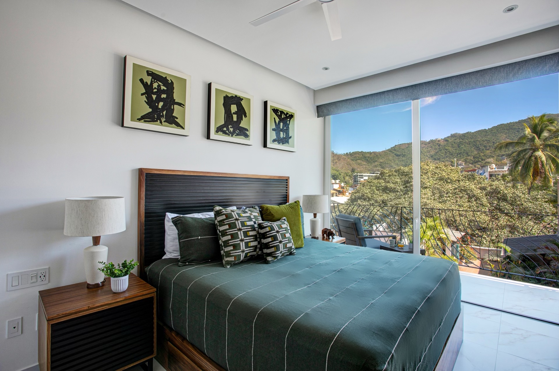 Master bedroom with balcony and sliding doors offering stunning mountain views.