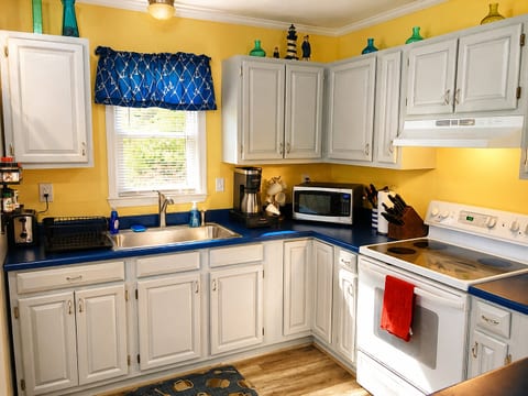 The kitchen boasts an extra deep sink, a Keurig that brews single cups or carafes, microwave, tea kettle, and more in this fully stocked kitchen! And the open floorplan means you can cook and not miss any of movie or game night in the living room!