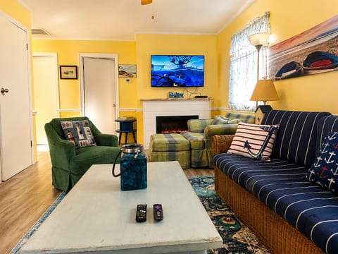 Kick back in your bright, beachy living room—plush seating, a cozy electric fireplace, and space for movie nights or quiet evenings. This welcoming hangout is yours to relax, reconnect, and unwind.