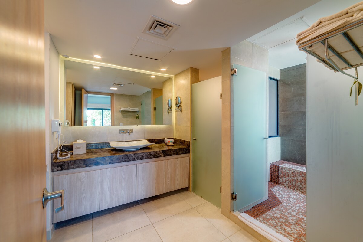Begin and end your day in a bathroom that feels like a personal spa. The elegant marble vanity is beautiful, but the true luxury is the spacious, walk-in shower, perfect for washing away the salt and sand after a glorious day on the beach. Oceanfront Retreat Aldea Thai at Mamitas Beach/5th