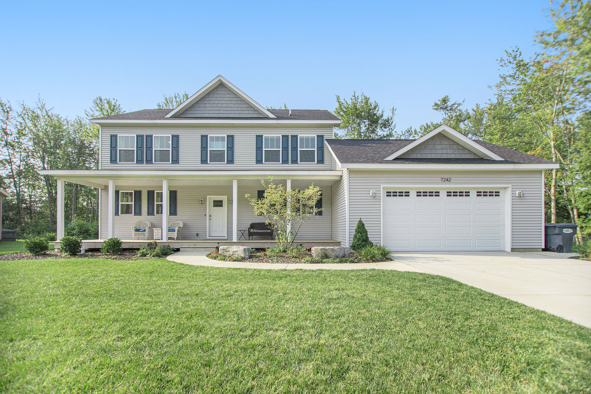 Front of house with 2 car garage, facing south. 
