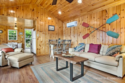 Livingroom featuring couch and chair with ottoman
