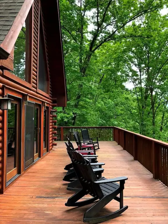 The spacious upper deck with rocking chairs overlooks the creek and the meadow beyond.  At the bottom of our property is the remnants of a 100 year old logging trail that was cut through this area. - LAURELWOOD LODGE - The Mountains are Calling! - Lake Lure