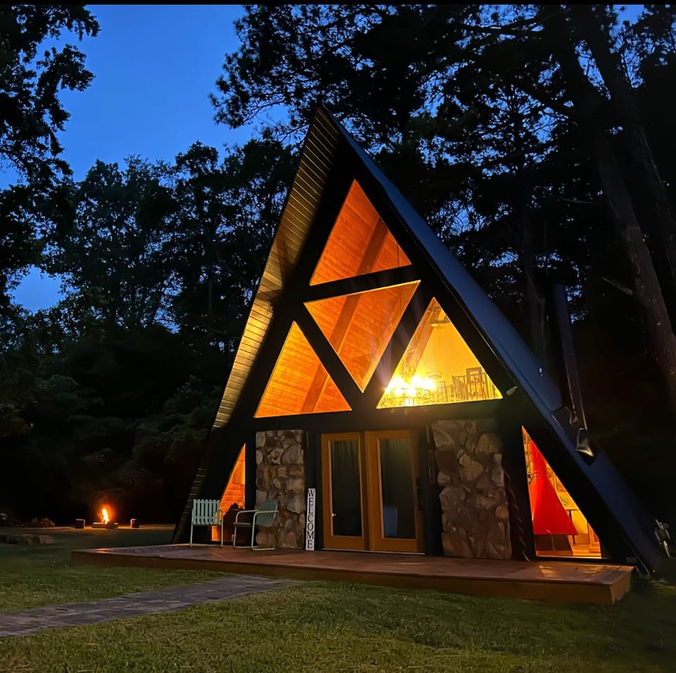 Captivating A-Frame retreat boasting unparalleled panoramic views. "The peace and serenity of this modern cabin is definitely a winner! Its cute charm and fun loft areas are unique.