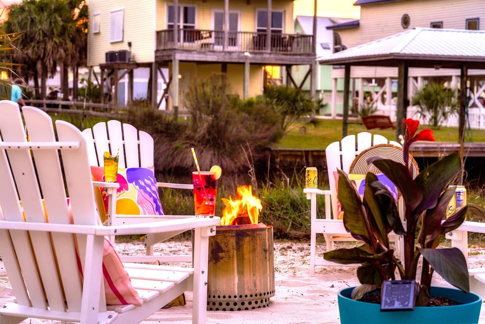 Unwind by the warm glow of the firepit as the Florida sky turns shades of orange and pink