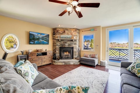 Cozy living room with wood burning fireplace and lake views!