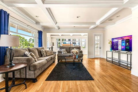 Cozy living room with two comfy couches perfect for relaxing. Enjoy movie nights on the large TV or unwind after a day of exploring. Bright, inviting space with plenty of room to gather, chat, or kick back in comfort. Ideal for families or friends!