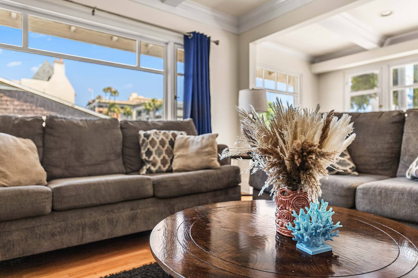 Spacious and inviting living room featuring two cozy couches and a large TV—perfect for relaxing after a day out. Ideal for movie nights, lounging, or spending quality time with family and friends in comfort. Bright and welcoming atmosphere