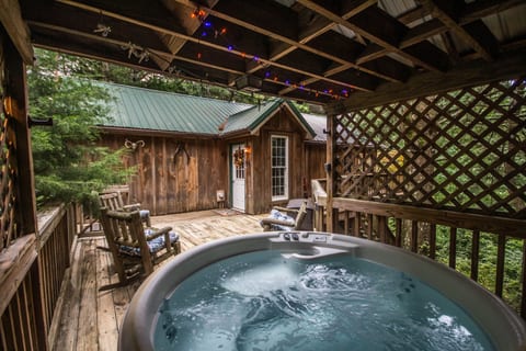 Modern hot tub just a few feet from the front door with gazebo overhead