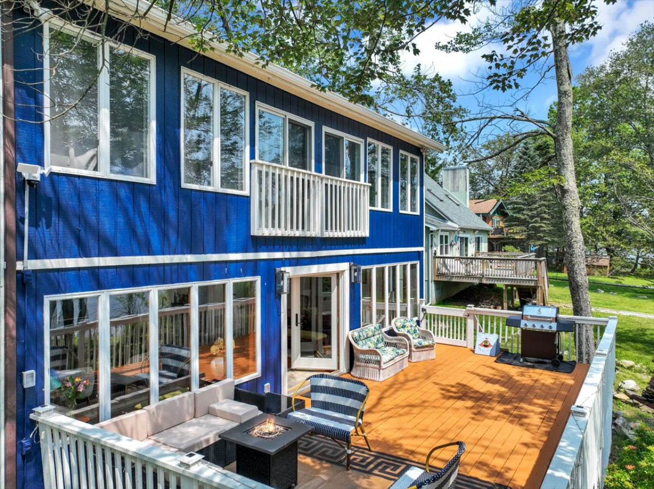 Gather with friends and family on the spacious back deck—complete with lake views, a fire pit table, grill, and plenty of seating.