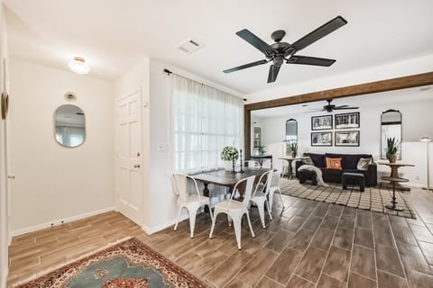 Entry way into the home where you are greeted with a warm inviting open concept living room, breakfast table and large kitchen