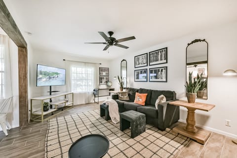 Living area with light airy feel and cozy warm ambiance of rustic finishes like the beam entryway