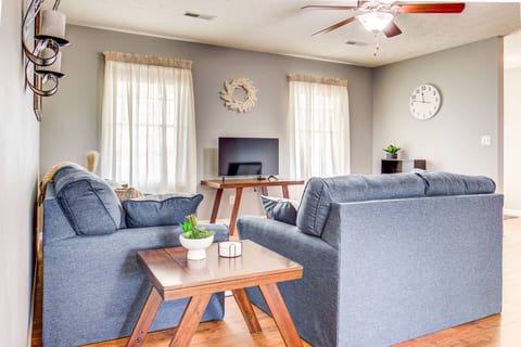 Modern & comfortable decor in living room, and windows overlooking green acres.