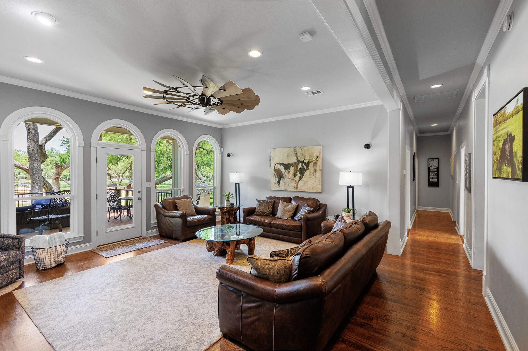 Main house loving room with oversized leather couches, fireplace with beautiful views of the pool 