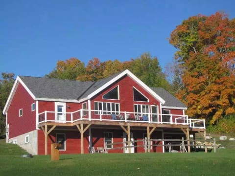 the view of the front of the home with the wrap around deck!