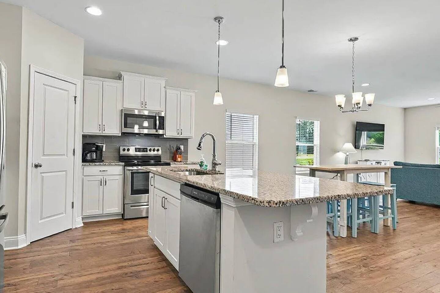 Spacious open concept kitchen, fully-stocked with stainless steel appliances, coffee bar, and pantry.