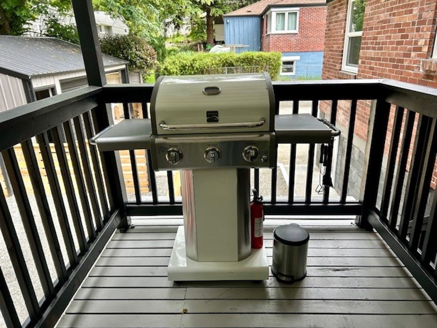 An upstairs gas BBQ with a view, perfect for grilling while overlooking the backyard and serene forest setting!