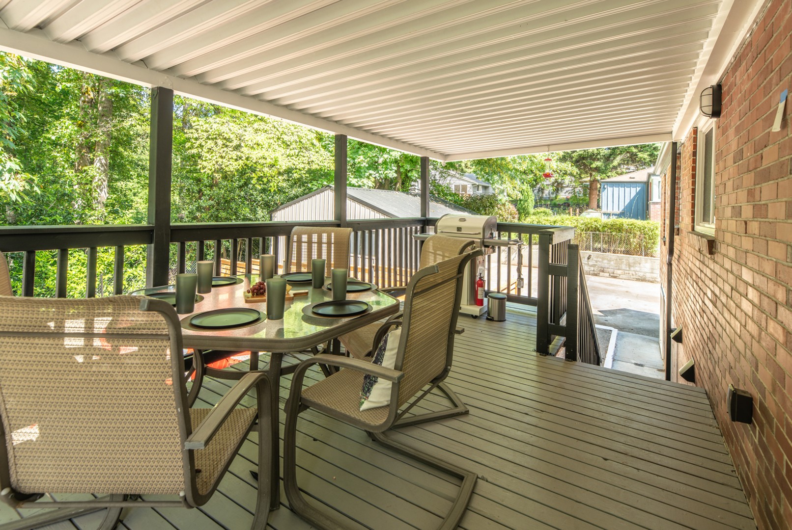 Enjoy the spacious back deck with stunning views of the forest, fire pit, and local wildlife. Stairs lead you down to the shared backyard and shed area, perfect for outdoor fun and relaxation!