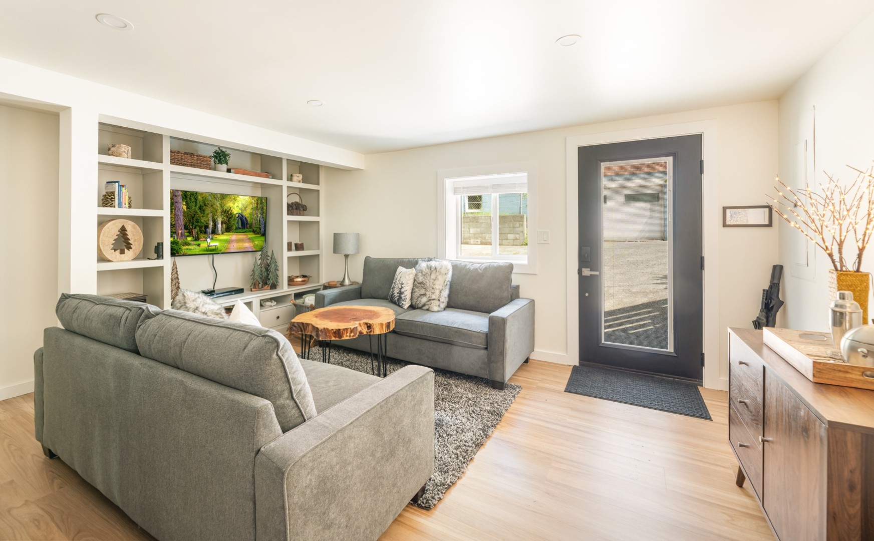 Relax in style in the lower level with our comfortable sofas, unique wooden coffee table, and a curated selection of vintage LPs for the record player