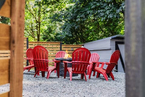 - Outdoor fire pit with bright red Adirondack chairs
- Gather around for cozy evenings in a private setting
- Perfect for stories laughter and memorable nights