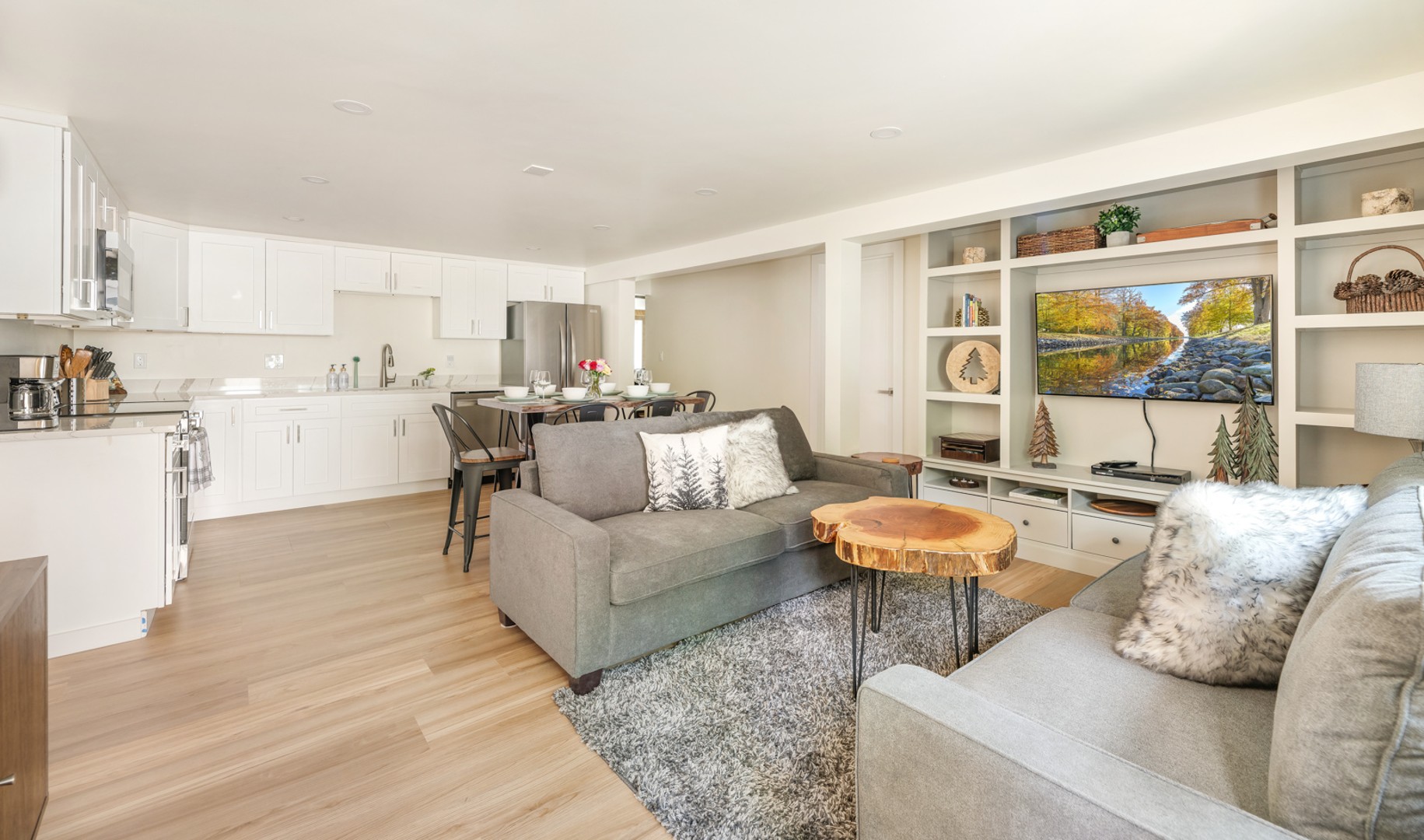 Open-concept lower level living space seamlessly connecting the kitchen, dining, and living areas, perfect for socializing and family gatherings