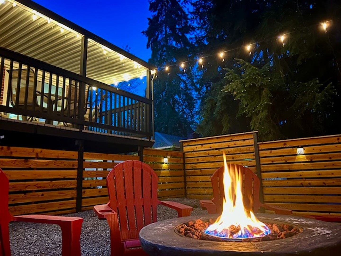 Gather under the trees at our private outdoor firepit, surrounded by forest and glowing with string lights—perfect for s’mores, stories, and starry nights.