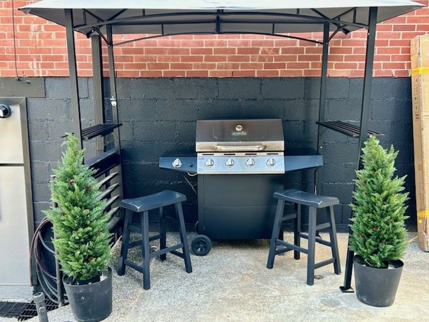 Private BBQ area with a gas grill and comfortable seating, perfect for outdoor dining and family gatherings.