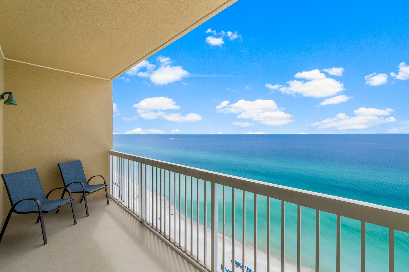 Breathtaking views from a private beachfront balcony with Adirondack chairs for the perfect spot to relax and enjoy the scenery.