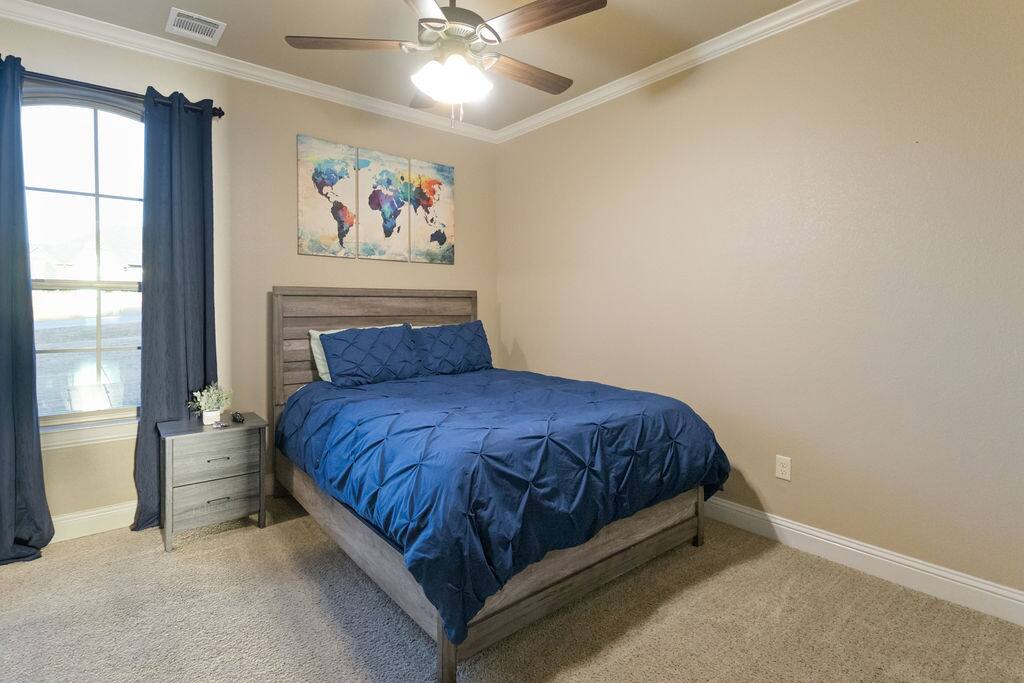 Find comfort in this peaceful queen bedroom, a serene spot for rest with all the comforts of home. - Luxe Retreat: Pool, Hot Tub, Jacuzzi, EV Charger - Granbury